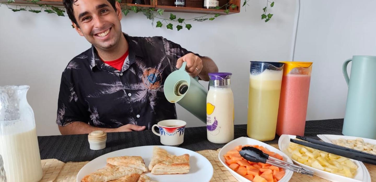 Host serving a colorful Cuban breakfast spread at Malecon Sunset guesthouse in Havana